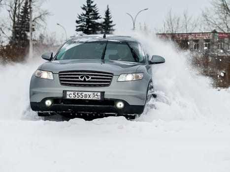 Moscow, Russia - January 24, 2019: Car infiniti QX70, winter photos of the car when driving through snowdrifts.