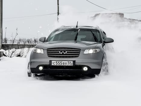 Moscow, Russia - January 24, 2019: Car infiniti QX70, winter photos of the car when driving through snowdrifts.