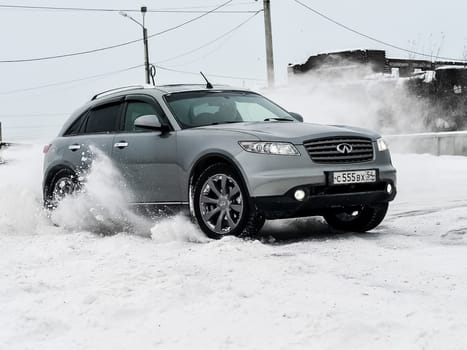 Moscow, Russia - January 24, 2019: Car infiniti QX70, winter photos of the car when driving through snowdrifts.