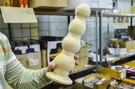 Rubber products factory for a sex shop. Workers process rubber penises. Reduction to the presentation of products. Sex toys.