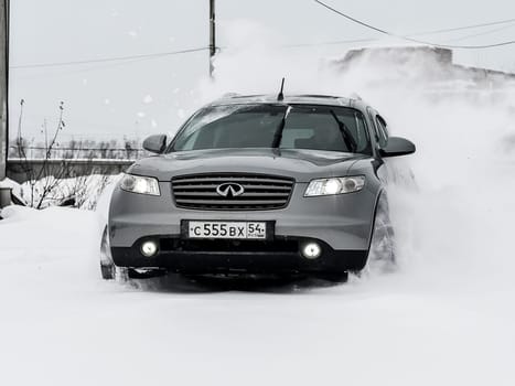 Moscow, Russia - January 24, 2019: Car infiniti QX70, winter photos of the car when driving through snowdrifts.