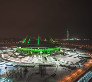 The roof of the stadium at night. Stadium lights.