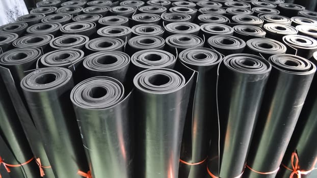 warehouse rolls of rubber. black coating rolls.