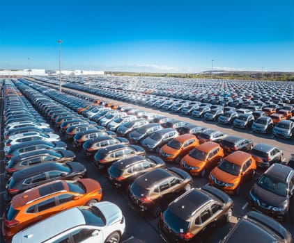 A large warehouse of cars on the site of the car dealership. Storage of new machines.