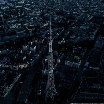 High communications tower in a residential area. Evening.