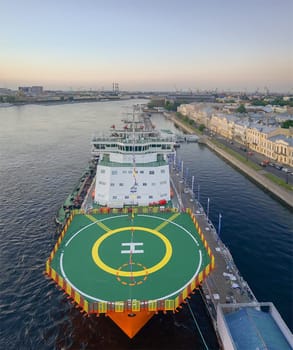 A ship with a helipad in the river port of St. Petersburg.