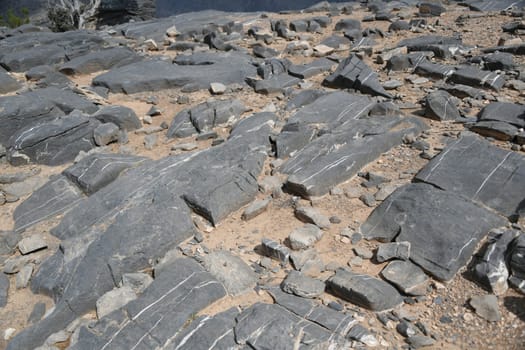Calcite veins in the limestone rock on the plateau in front of the Grand Canyon of Jabal Shams in Oman.
