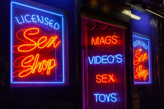 Sex shop neon sign advertising an adult licensed business in the Soho red light district industry, stock image photo