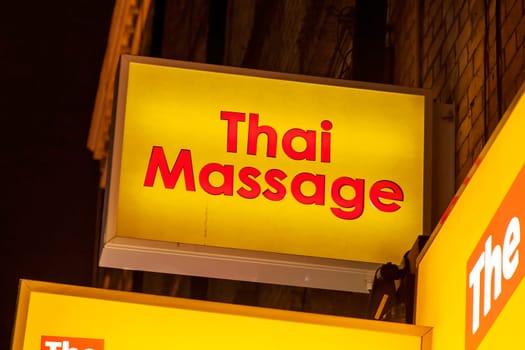 Thai massage sex shop neon sign advertising an adult licensed business in the Soho red light district industry, stock image photo