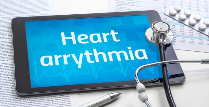 The word Heart arrythmia on the display of a tablet