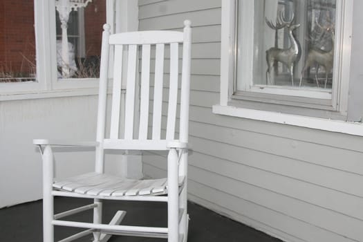 Vintage white rocking chair on front porch