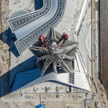 Workers installers at the height work at the top of the skyscraper.