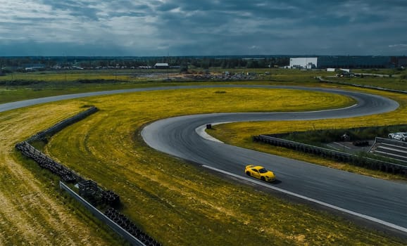 Yellow car on the race track. A section of the race track.