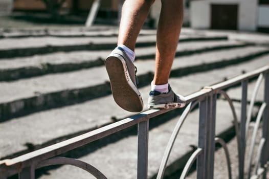 The guy in the sneakers is walking on the fence. Climb over the fence.