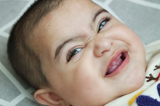 Baby girl with lovely face, big eyes and cute face gesture. Toddler baby making sweet activities