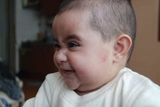Baby girl with lovely face, big eyes and cute face gesture. Toddler baby making sweet activities