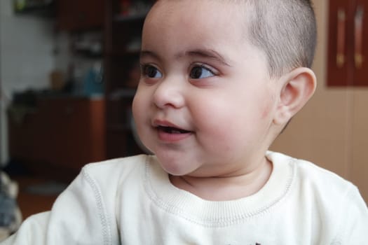 Baby girl with lovely face, big eyes and cute face gesture. Toddler baby making sweet activities