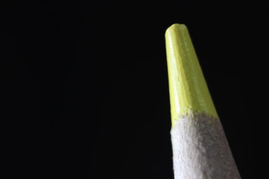 close up of sharpened pencil.Macro view of the tip of the pencil on a black background.