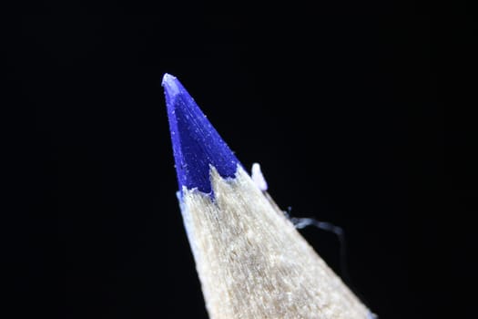 close up of sharpened pencil.Macro view of the tip of the pencil on a black background.