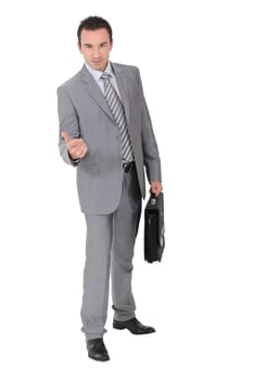 Businessman beckoning in a studio