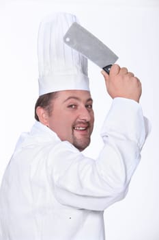 Chef in uniform wielding a cleaver