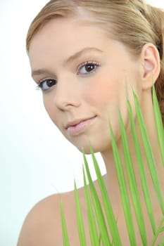 Blond woman holding leaf
