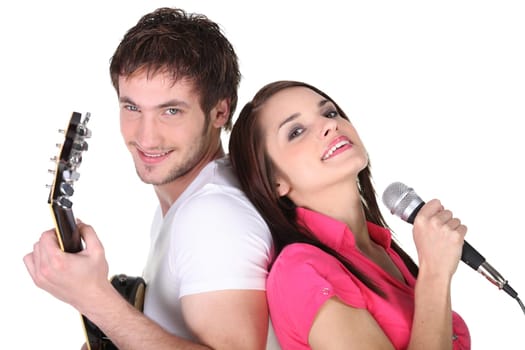 Young couple singing and playing guitar