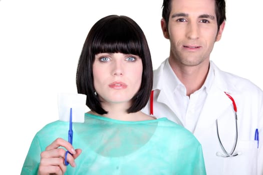 Hospital doctor and nurse holding a sterile gauze