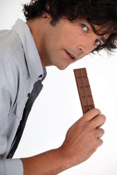 Young man with chocolate bar