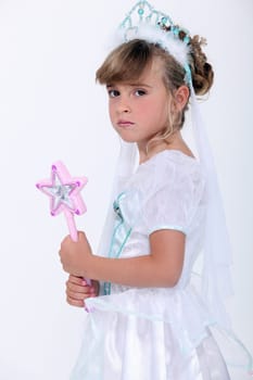 Little girl dressed as princess holding wand