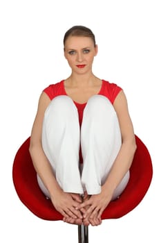 Blond woman sat in expensive designer chair