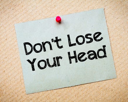 Recycled paper note pinned on cork board.Don' t Postpone Message. Motivational Concept Image
