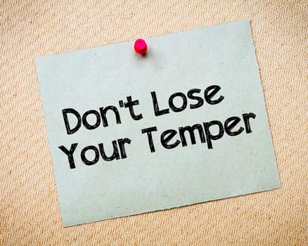 Recycled paper note pinned on cork board.Don' t Postpone Message. Motivational Concept Image