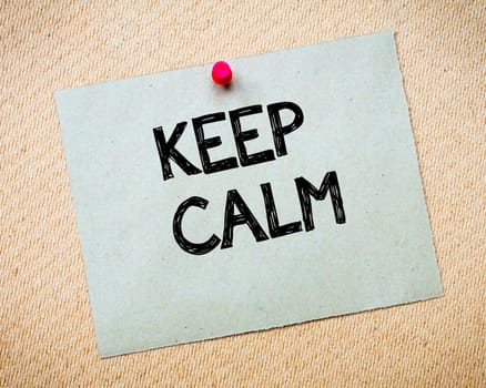 Recycled paper note pinned on cork board. Keep Calm Message. Motivational Concept Image