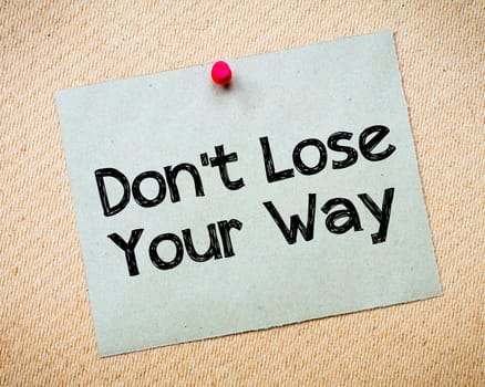 Recycled paper note pinned on cork board.Don' t Postpone Message. Motivational Concept Image