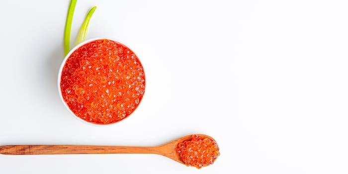 Red caviar in a wooden cup on a white background with a spoon. Place for advertisement, logo, label, mockup, mock-up.