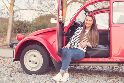 Woman going on a roadtrip in her convertible car