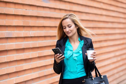 Business woman with coffe and talking on the phone near office