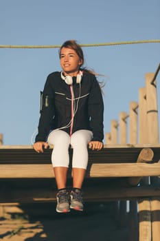 Young beautiful chinese woman exercising at the beach at sunrise/sunset