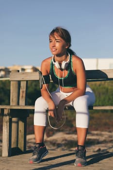 Young beautiful chinese woman exercising at the beach at sunrise/sunset