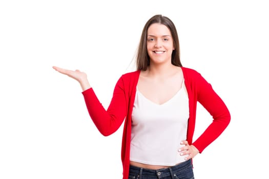 Young beautiful woman presenting your product, isolated over white background