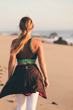Young beautiful chinese woman exercising at the beach at sunrise/sunset