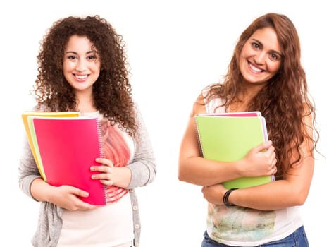 Young happy students posing over white background