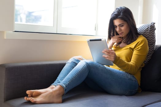 Beautiful young woman relaxing at the living room