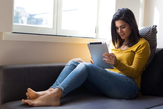 Beautiful young woman relaxing at the living room