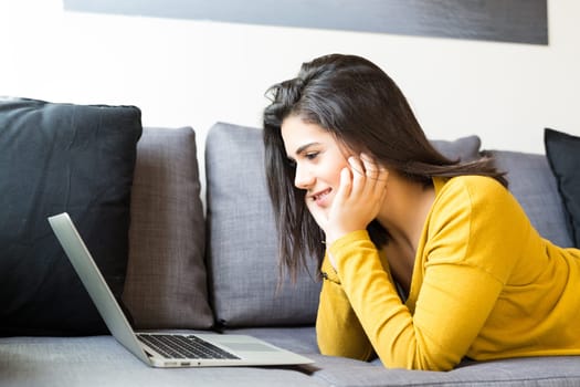 Beautiful woman relaxing with a computer