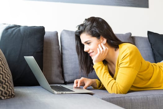Beautiful woman relaxing with a computer