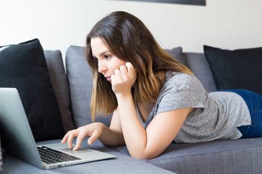 Beautiful woman relaxing with a computer