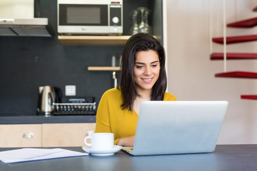 Young woman working at home in the morning