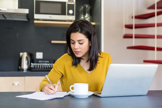 Young woman working at home in the morning